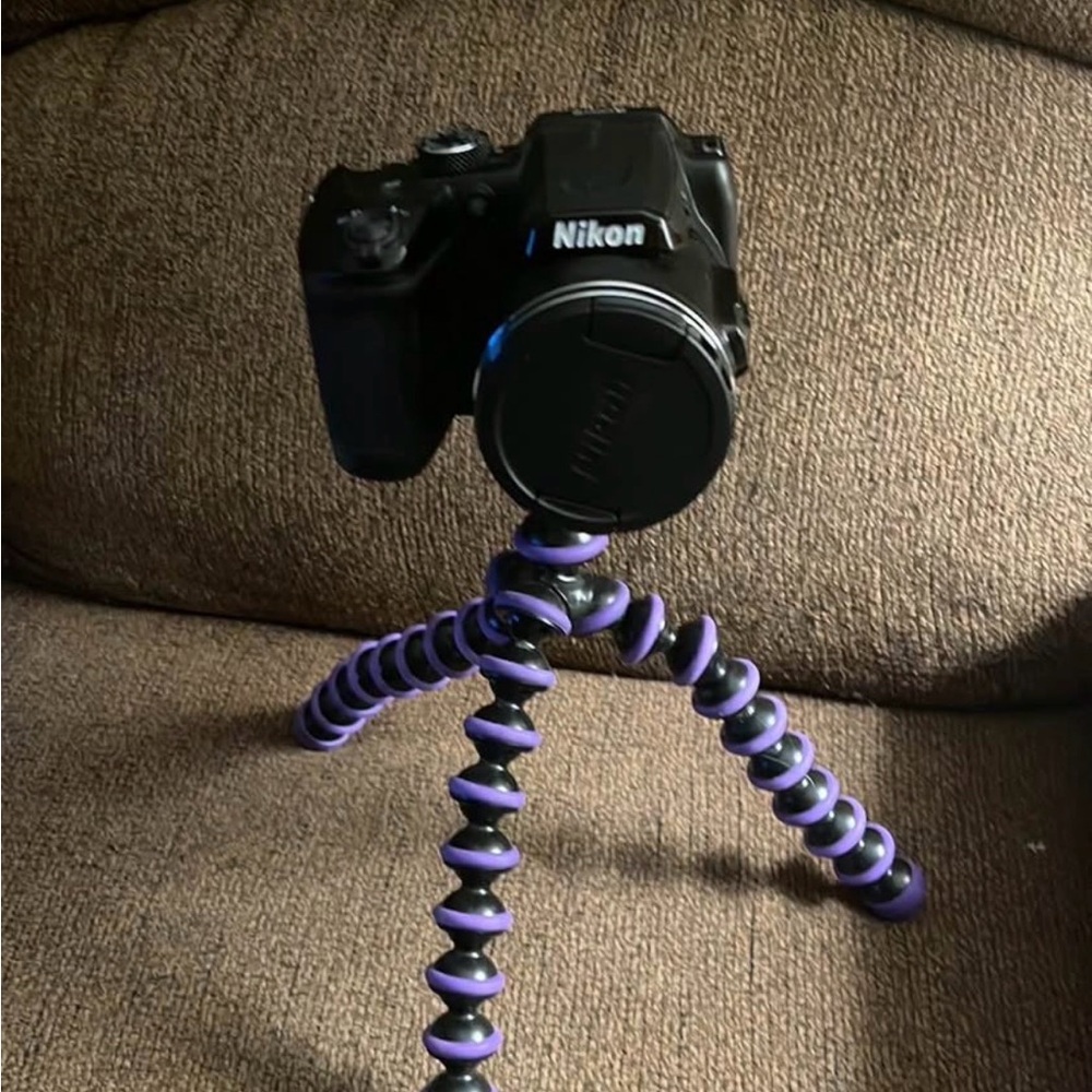 Nikon Black Camera with Purple Flexible Tripod